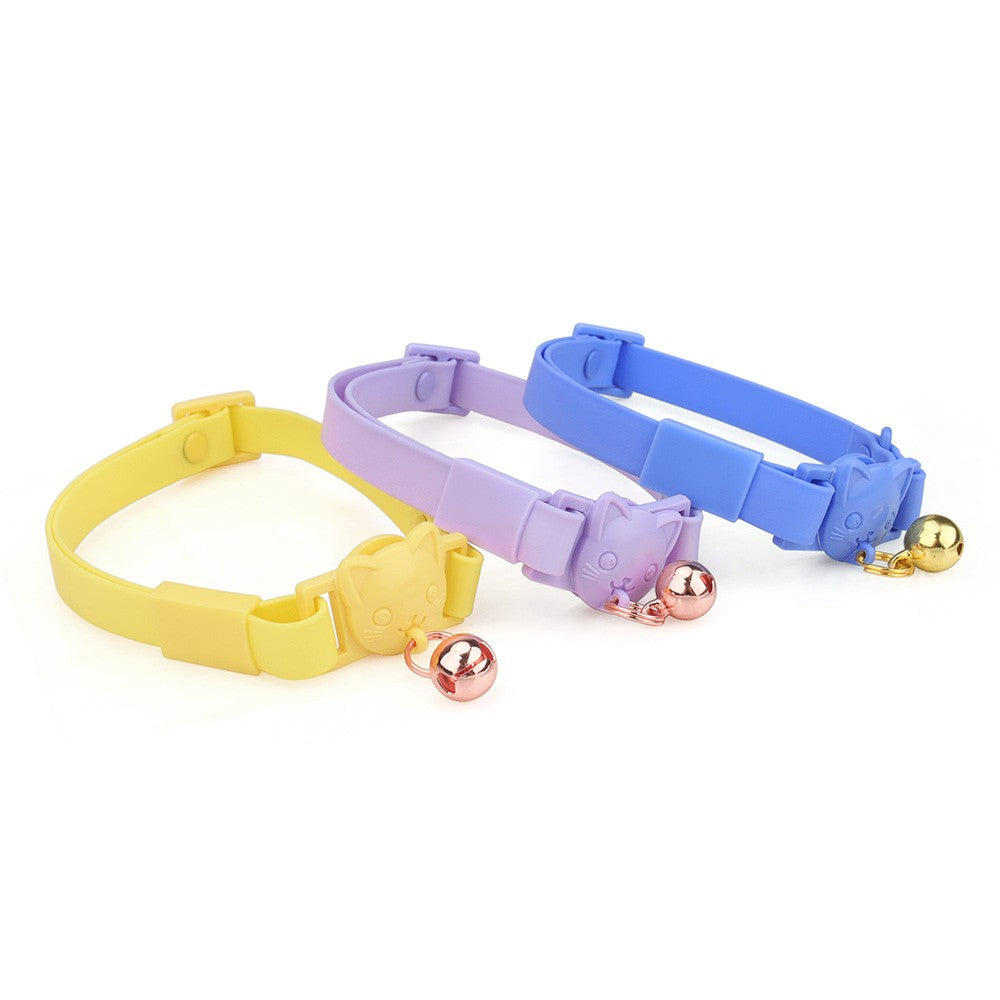 Yellow, lilac and blue cat collars with bells side by side