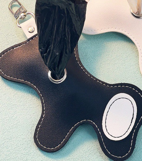 Black dog-shaped poop bag dispenser with a bag pulled through the eyelet