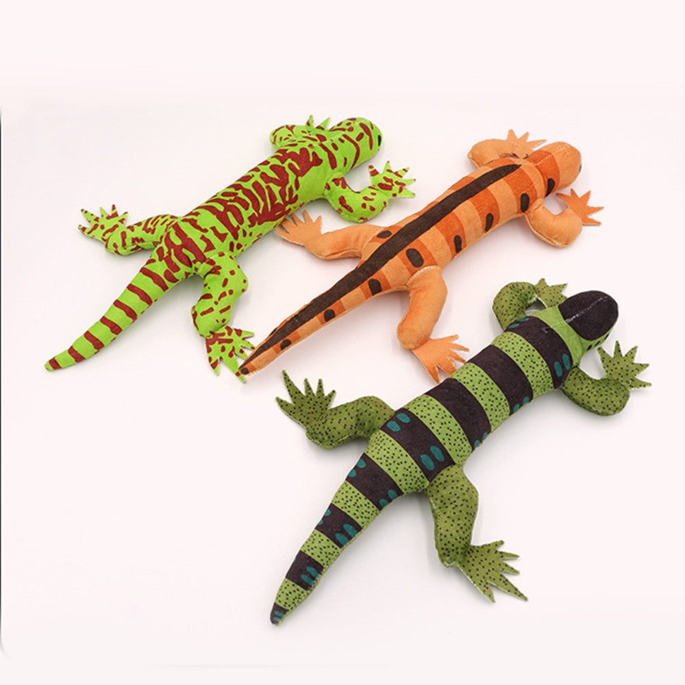 Three lizard kicker toys laid out side by side