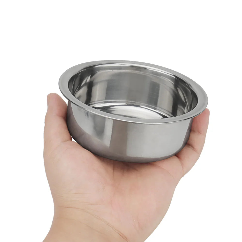 Stainless steel dog bowl held in one hand to show its size