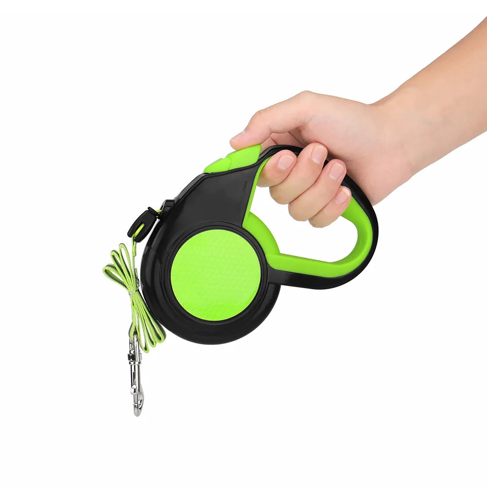 Green retractable dog leash held in one hand, showing the grip