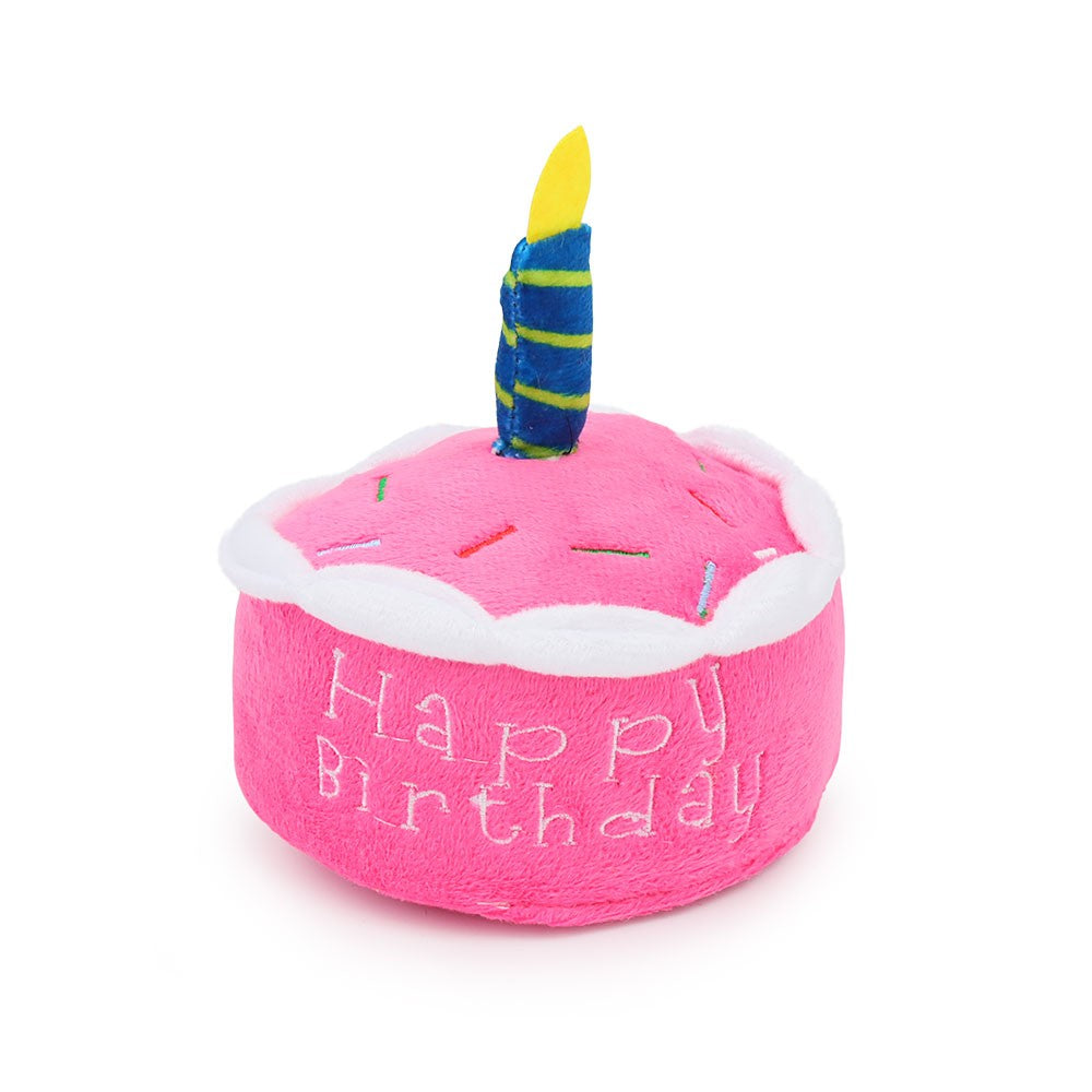 Pink round Happy Birthday cake dog toy with a striped candle