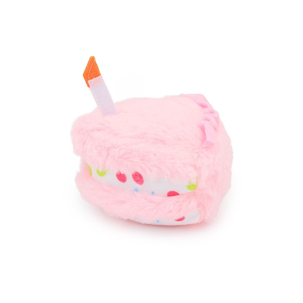 Pink cake slice dog toy with a candle