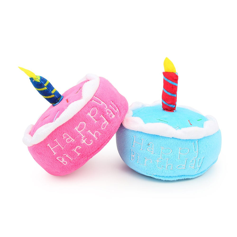 Two round birthday cake dog toys tipped on their sides