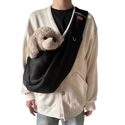 Black mesh shoulder bag worn crossbody, shown with a plush toy dog