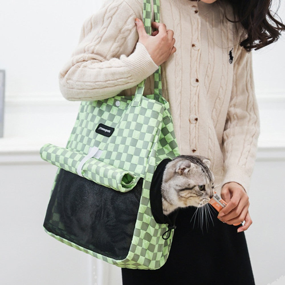 Green check carrier bag with a cat looking out