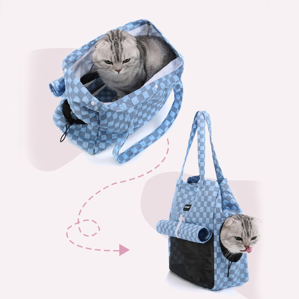 Cat climbing into the carrier bag through the top opening