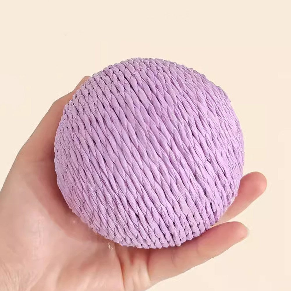 Lilac scratching ball held in a hand to show its size