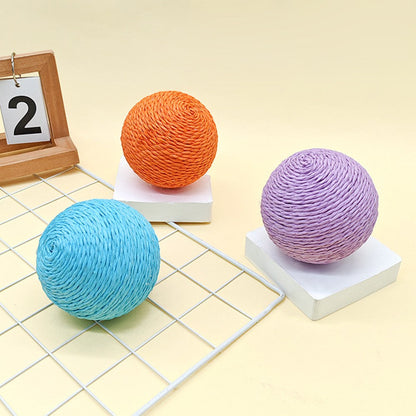 Orange, blue and lilac scratching balls on a desk