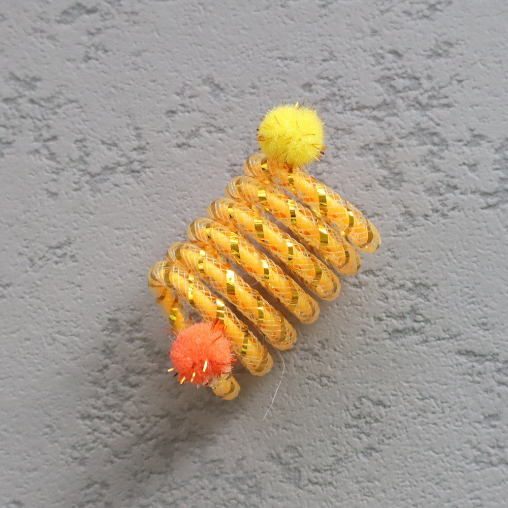 Yellow cat spring toy with orange and yellow pom-poms