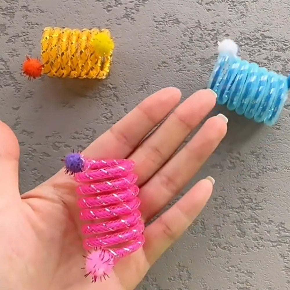 Pink spring toy on a palm to show its small size