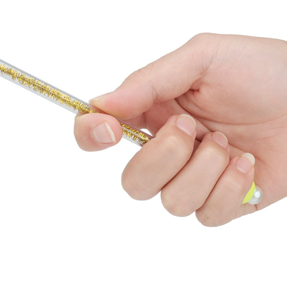 Glittery rod of the tassel cat toy held in a hand