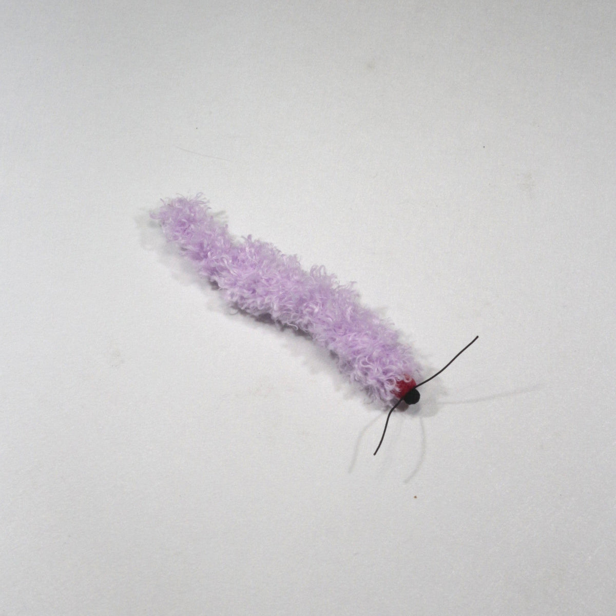 Light purple caterpillar cat toy on a white background