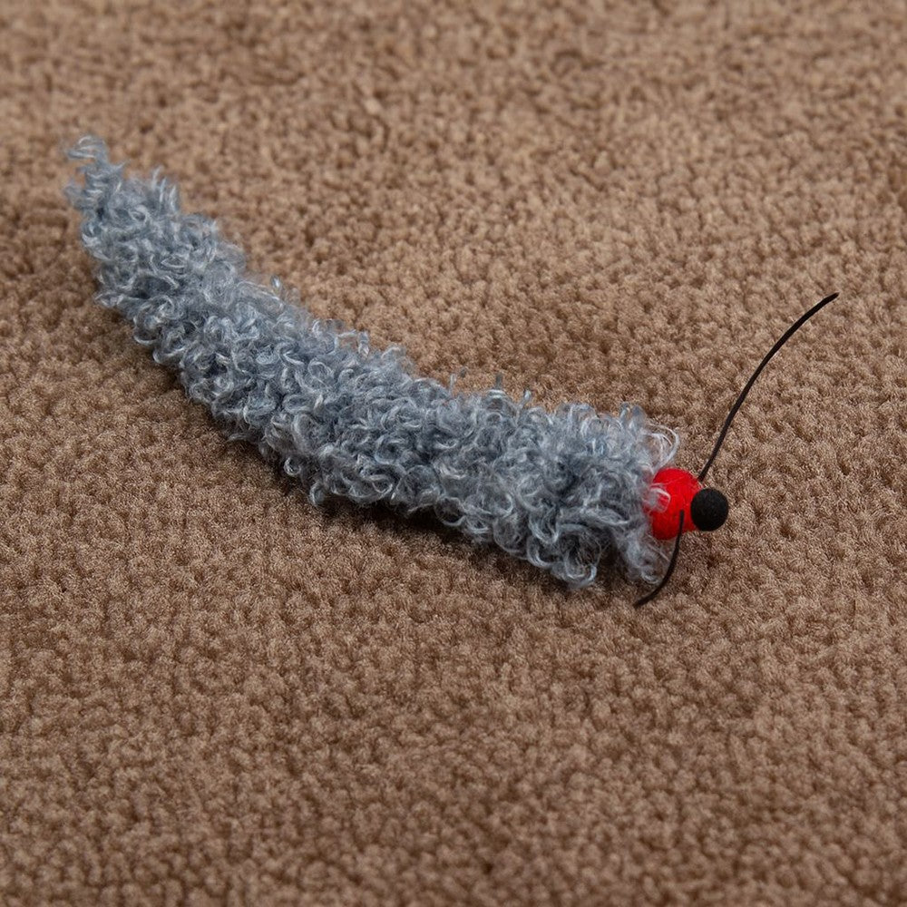 Close-up of the fuzzy gray caterpillar and its red head
