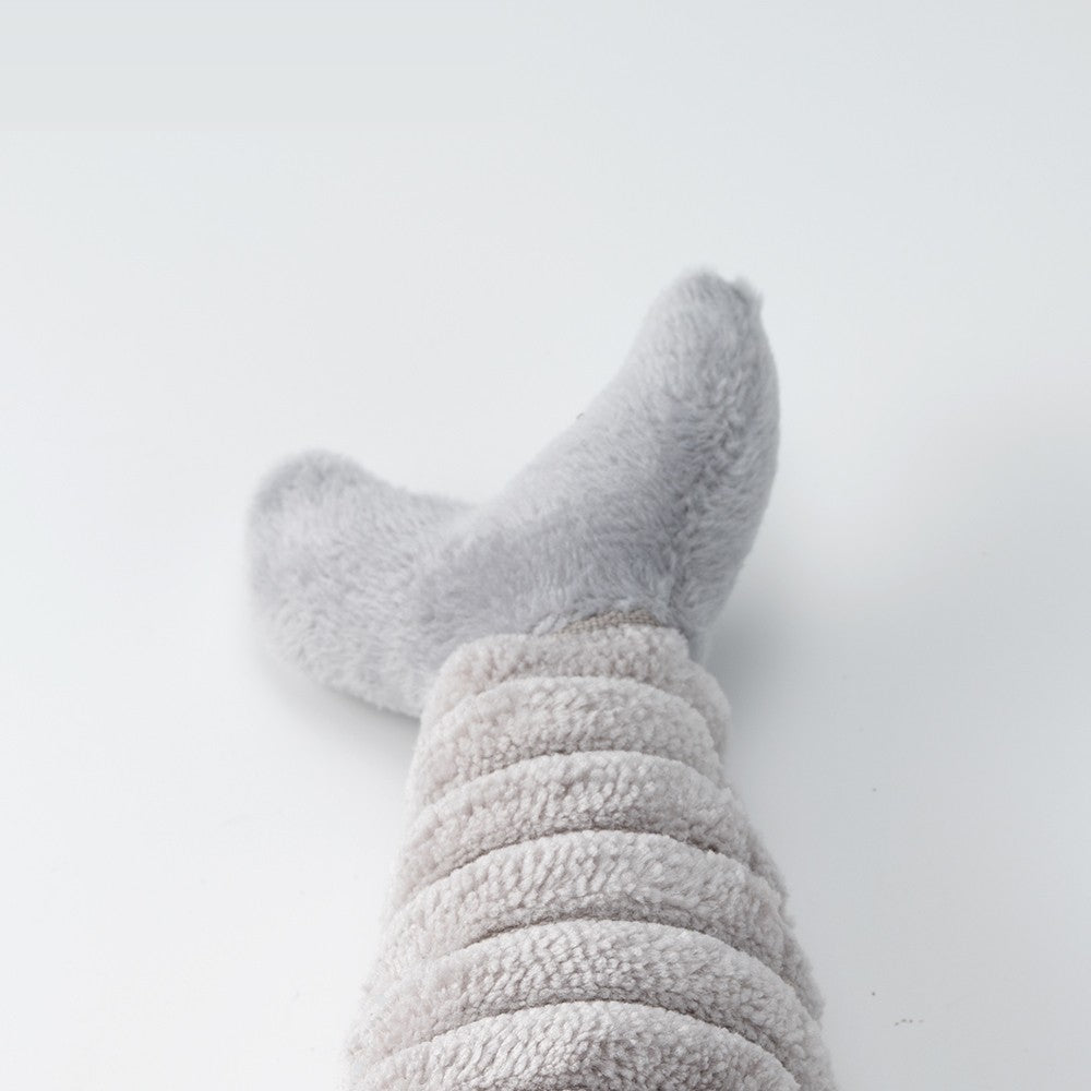 Close-up of the soft tail on the gray plush fish cat toy