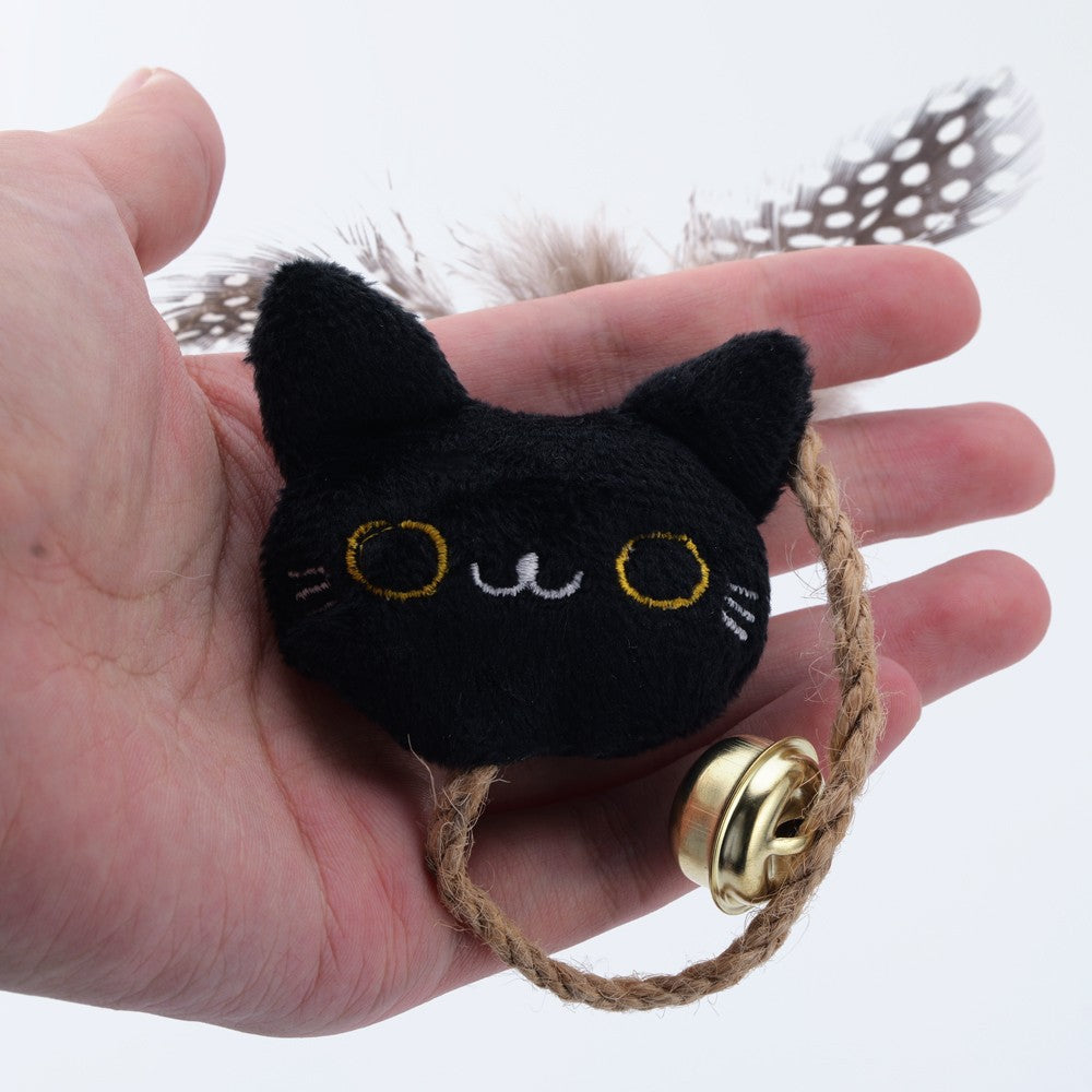 Black cat face catnip toy with a feather tail, bell and rope loop