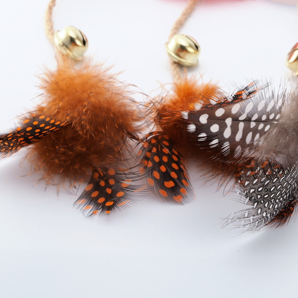 Close-up of the feathers and bells on the catnip rope toys