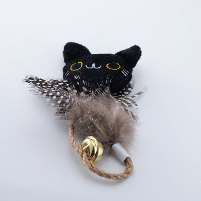 Black cat face catnip toy with gray feathers and a bell