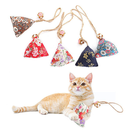 Kitten lying near hanging catnip sachets