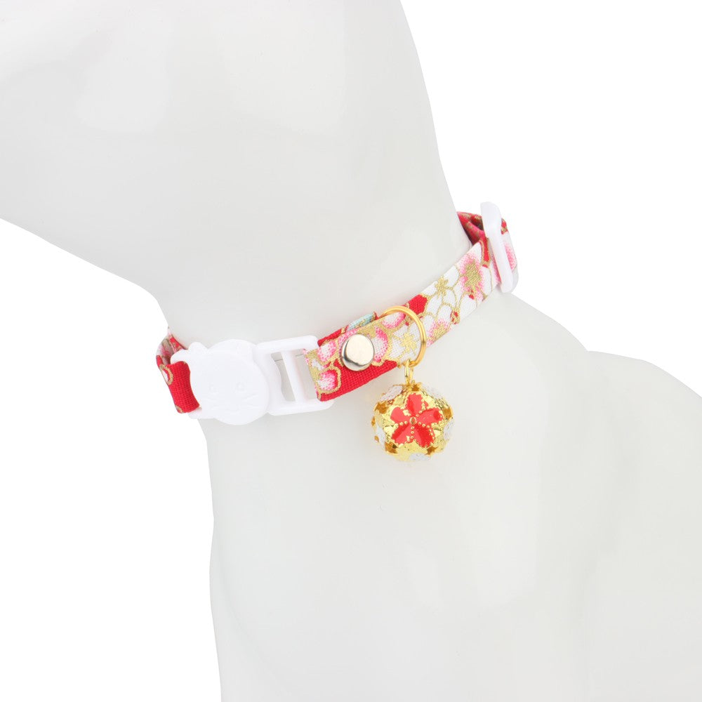 Red cherry blossom collar on a cat figure