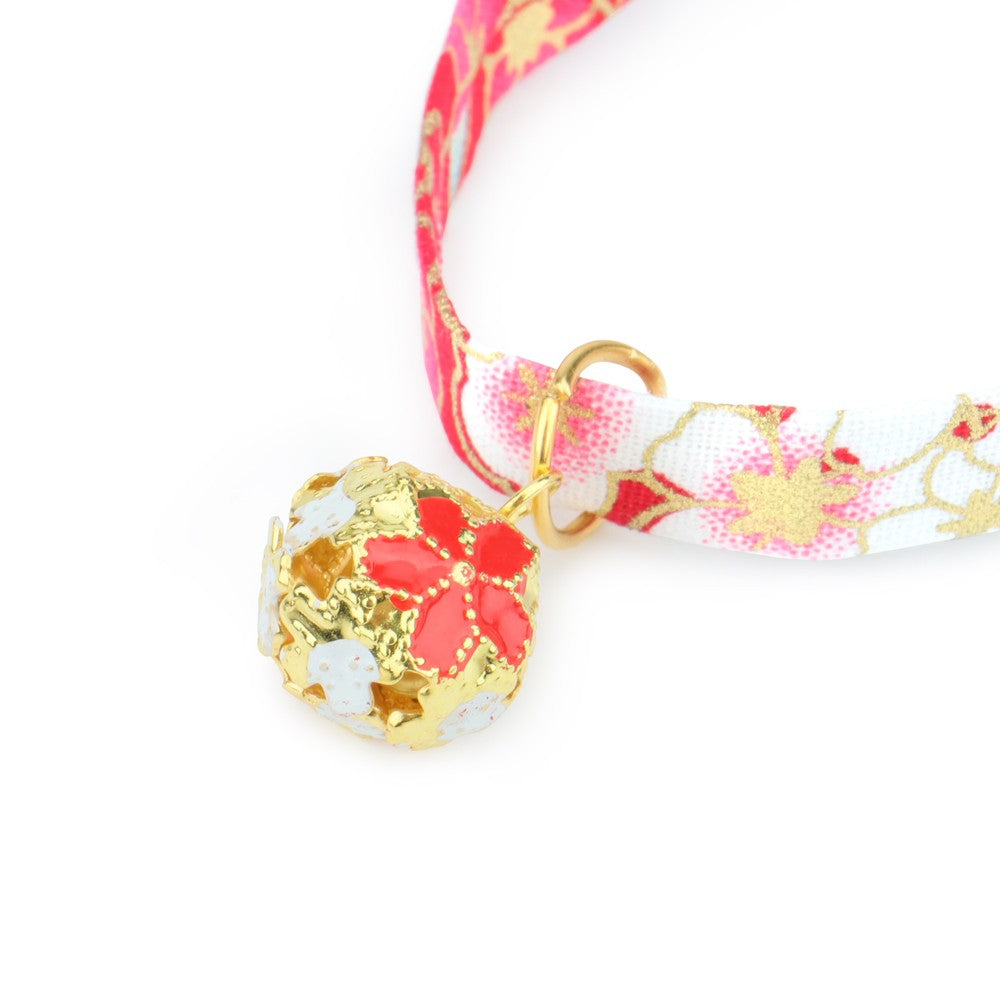 Close-up of the gold bell with pink blossom design