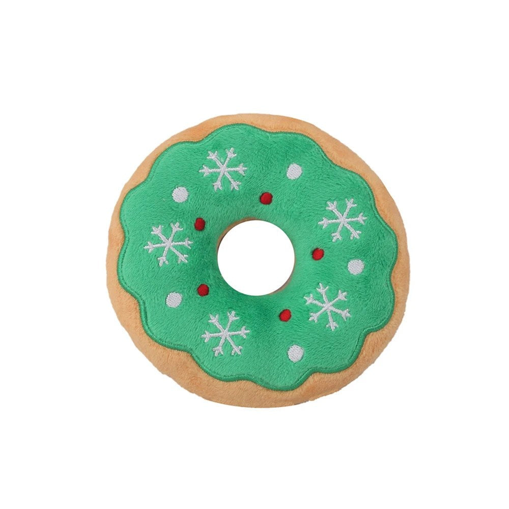 Green donut dog toy with snowflake icing, top view
