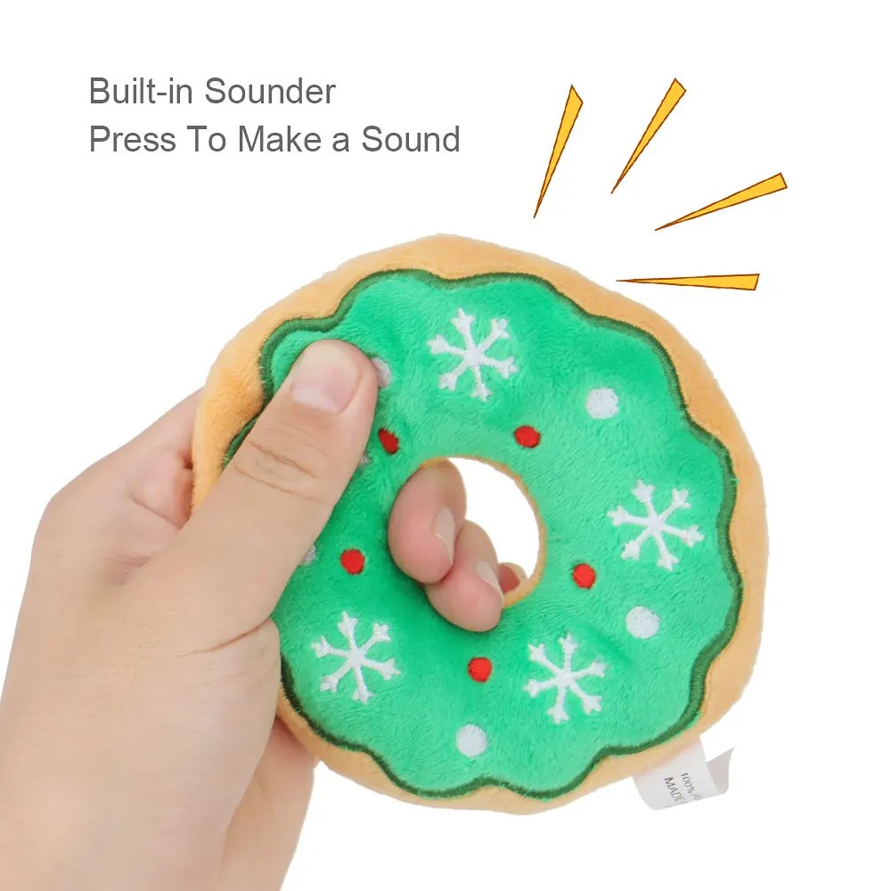 Hand squeezing the green donut dog toy, with a caption about the built-in squeaker