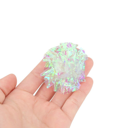 Crinkle ball held in a hand to show its 5 cm size