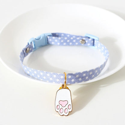 Blue star print cat collar with a white paw charm