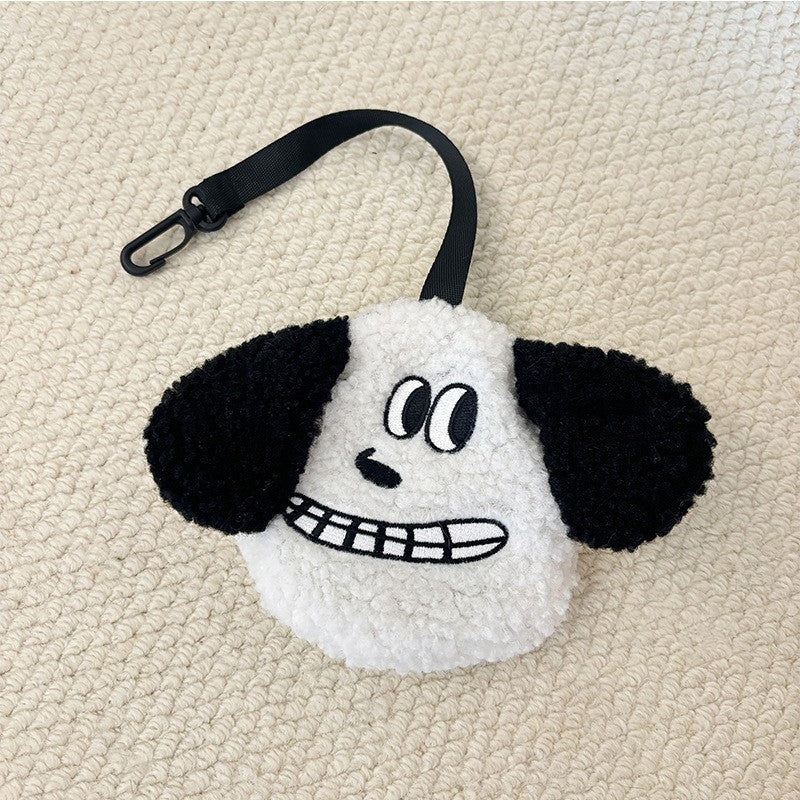 White plush poop bag holder with a grinning face and black ears