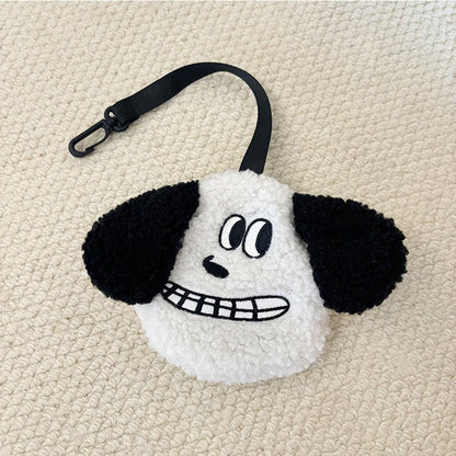 White plush poop bag holder with a grinning face and black ears