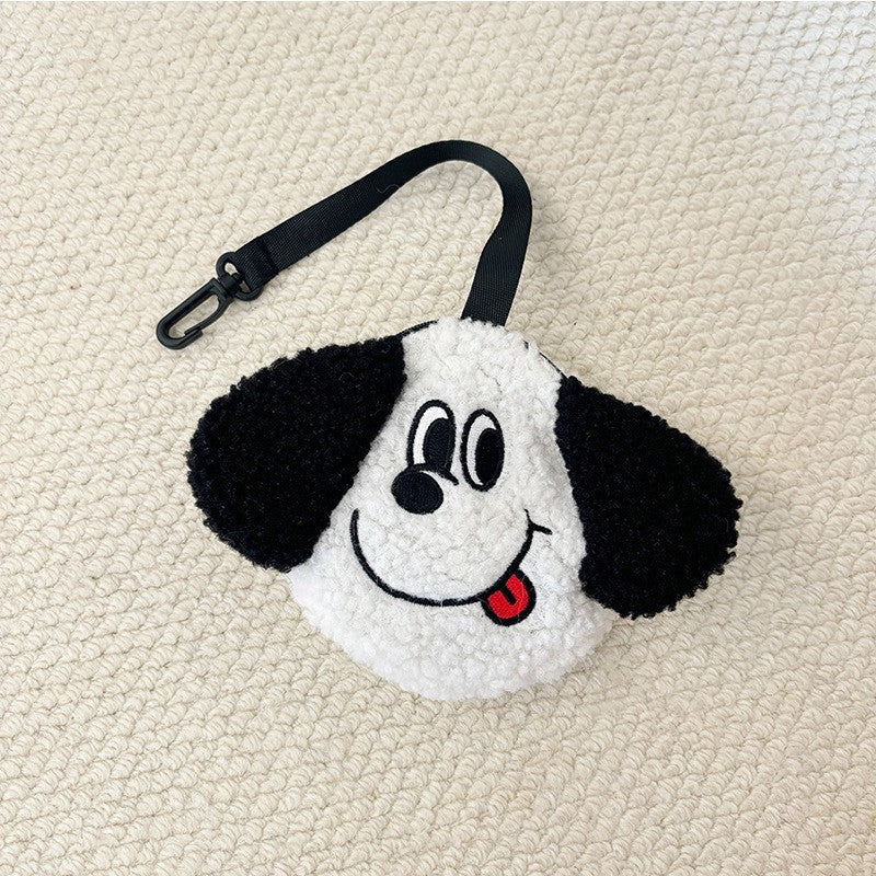 White plush poop bag holder with a tongue-out face and black ears