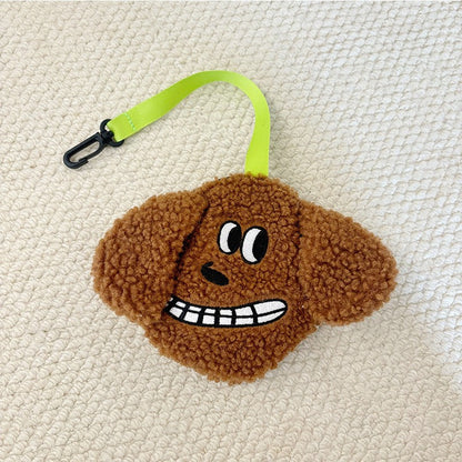 Brown plush poop bag holder with a grinning face