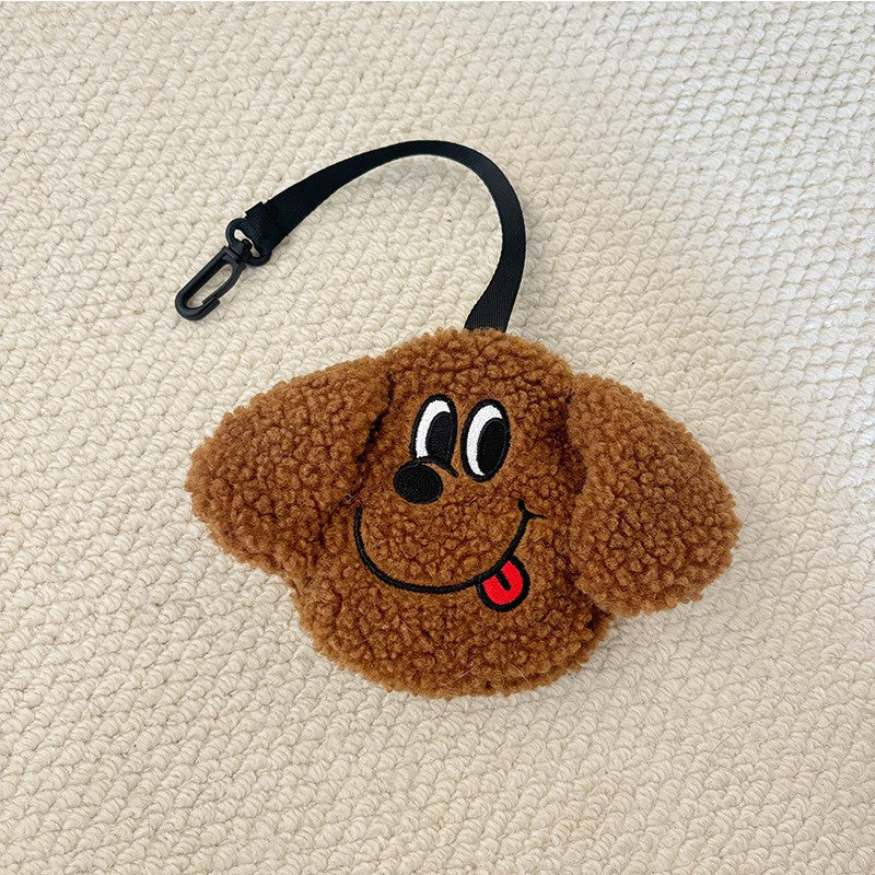 Brown plush poop bag holder with a tongue-out face
