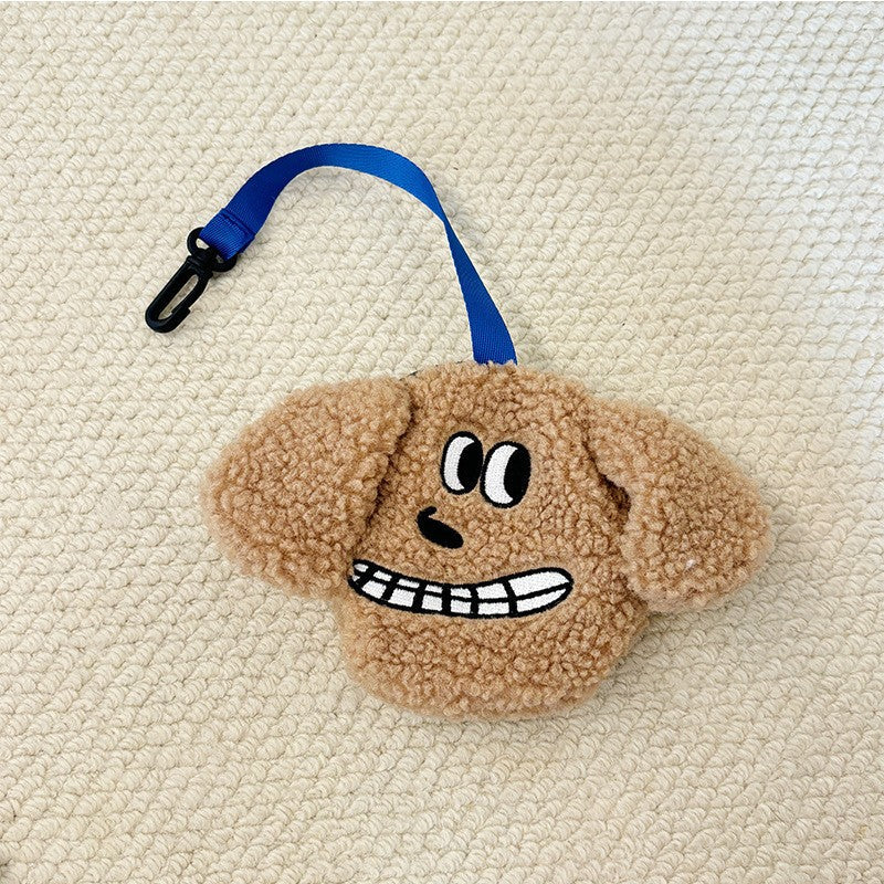Tan plush poop bag holder with a grinning face
