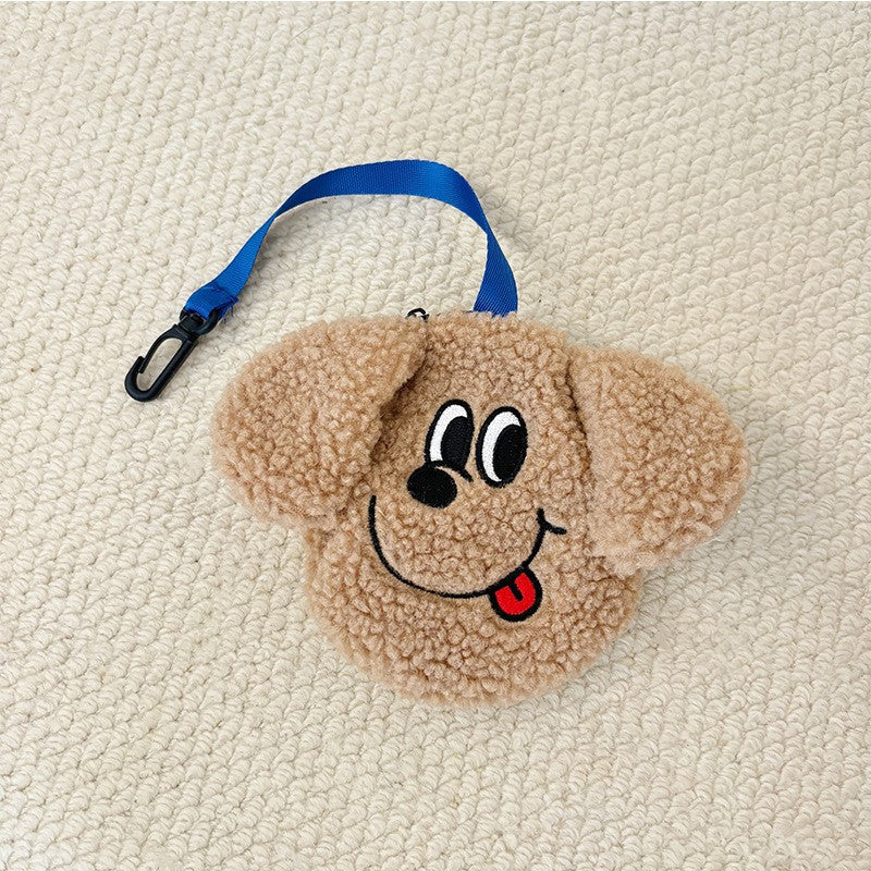 Tan plush poop bag holder with a tongue-out face