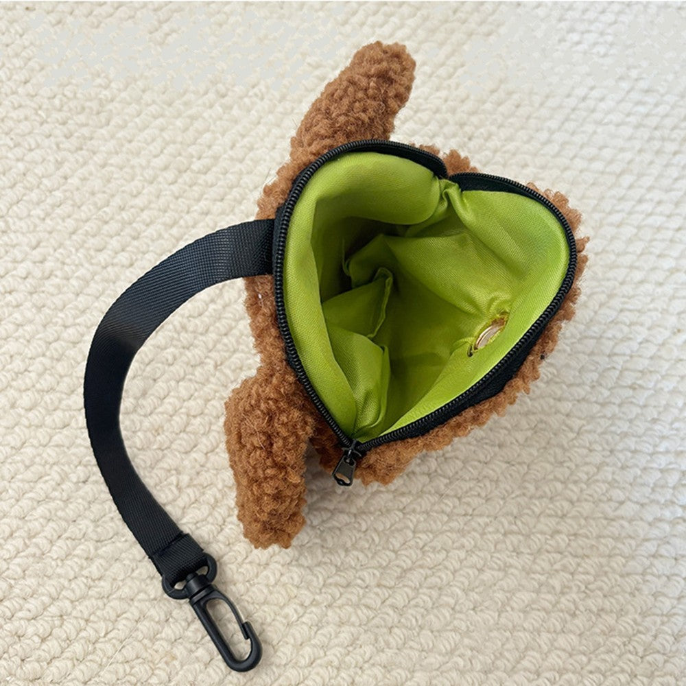 Inside of the plush poop bag holder with a green lining and clip strap