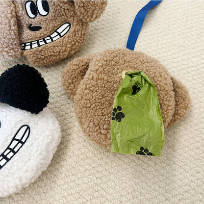 Poop bag roll pulled through the plush holder