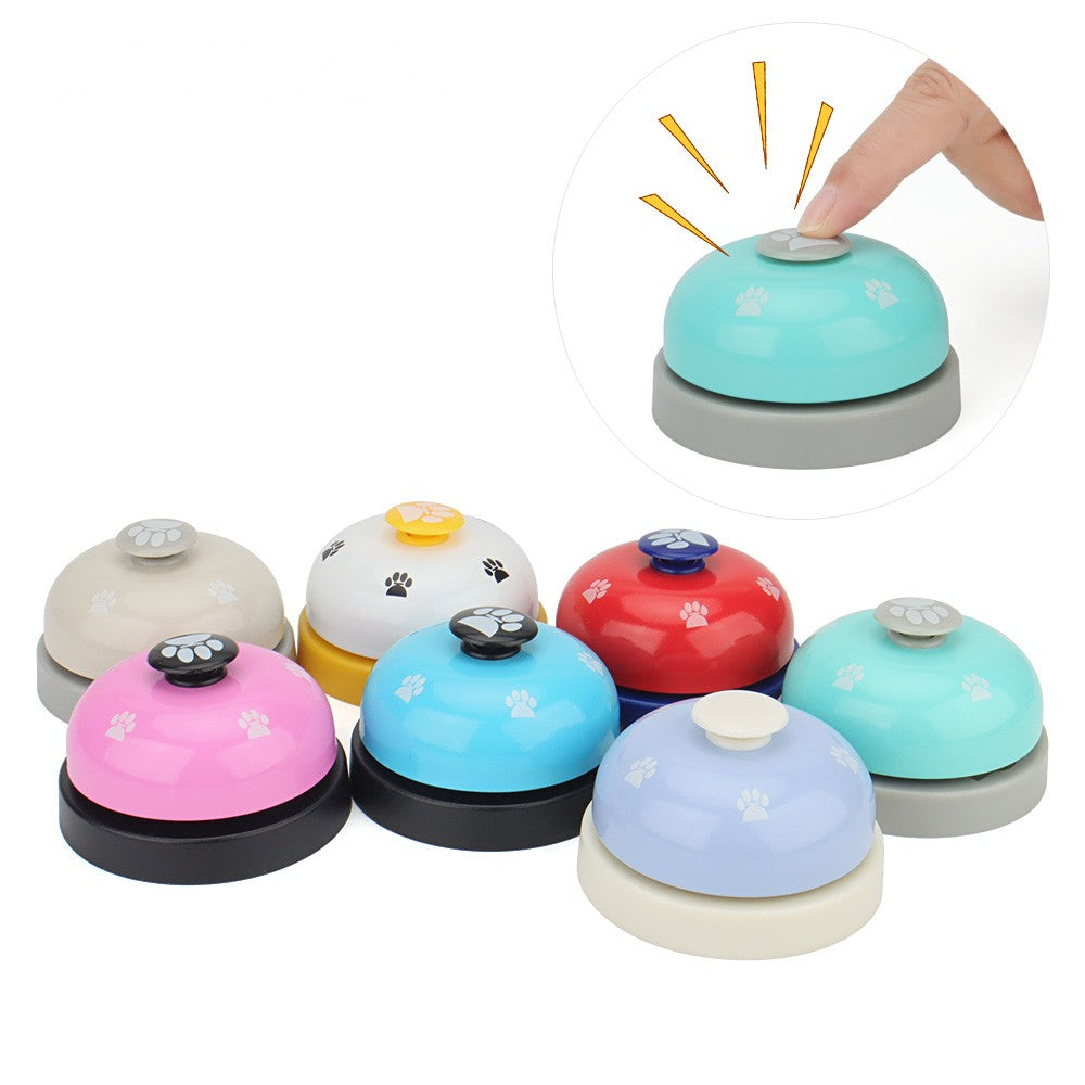 Finger pressing the button on top of a dog potty bell
