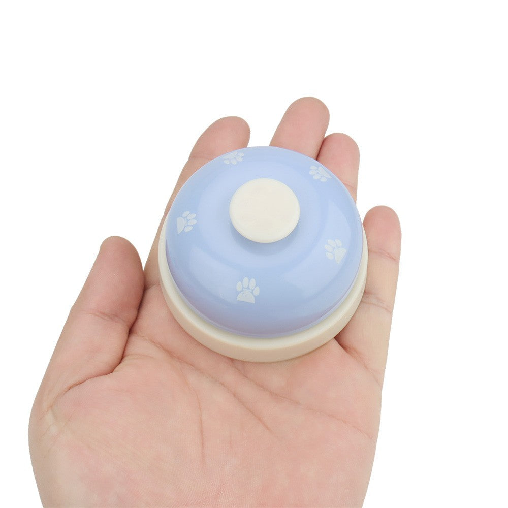 Dog potty bell in the palm of a hand to show the size