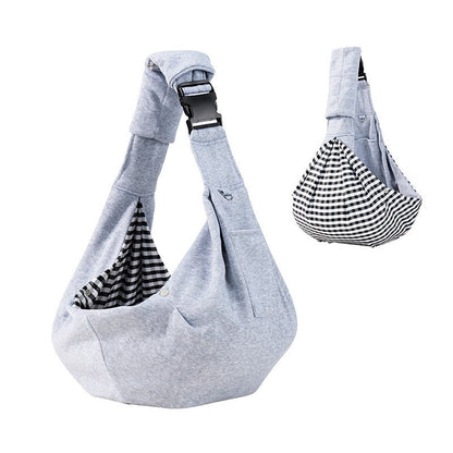 Light gray dog sling carrier with reversible houndstooth side