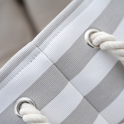 Close-up of the cotton rope handle and metal eyelet on the dog toy basket