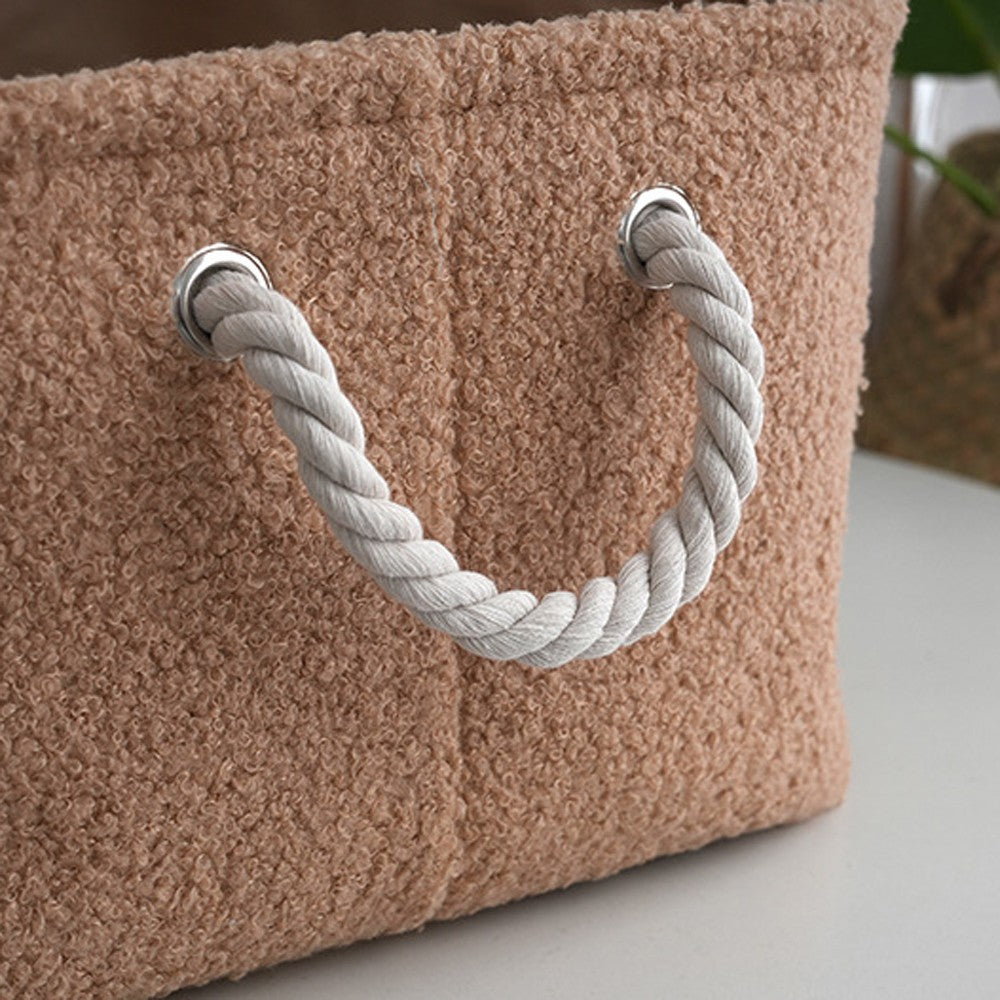 Close-up of the cotton rope handle on the brown plush toy box
