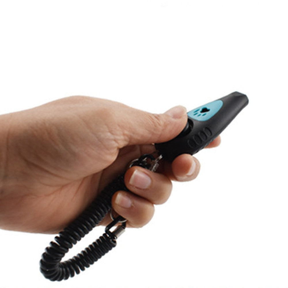 Whistle clicker held in the hand with the wrist strap on