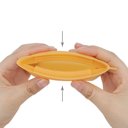 Squeezing the sides of the silicone treat pouch to pop the mouth open