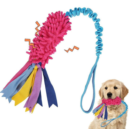 Golden puppy pulling the pink tug toy on its stretchy bungee handle