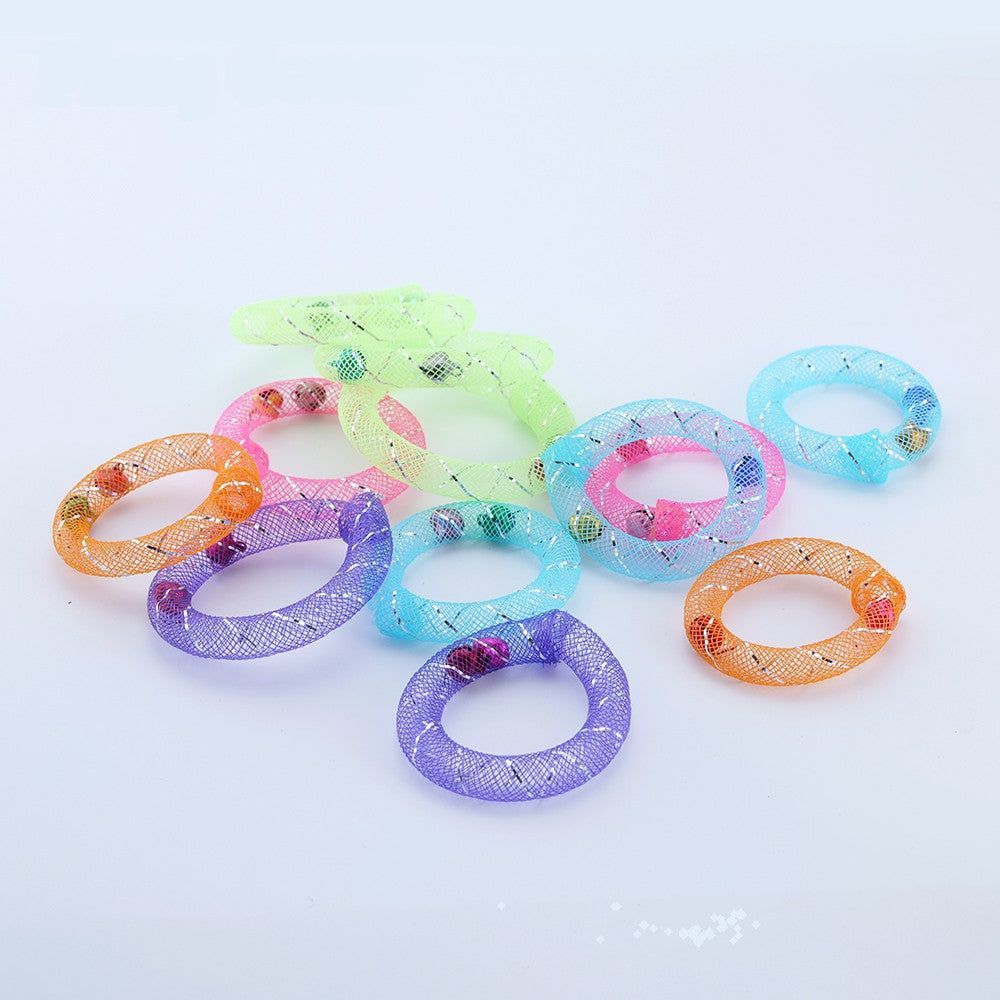 Scattered ring toys showing the bells inside each mesh tube