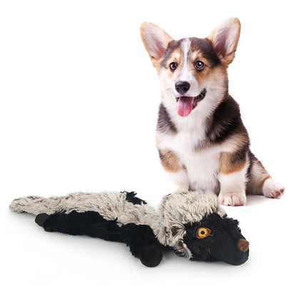 Corgi lying beside the honey badger plush dog toy