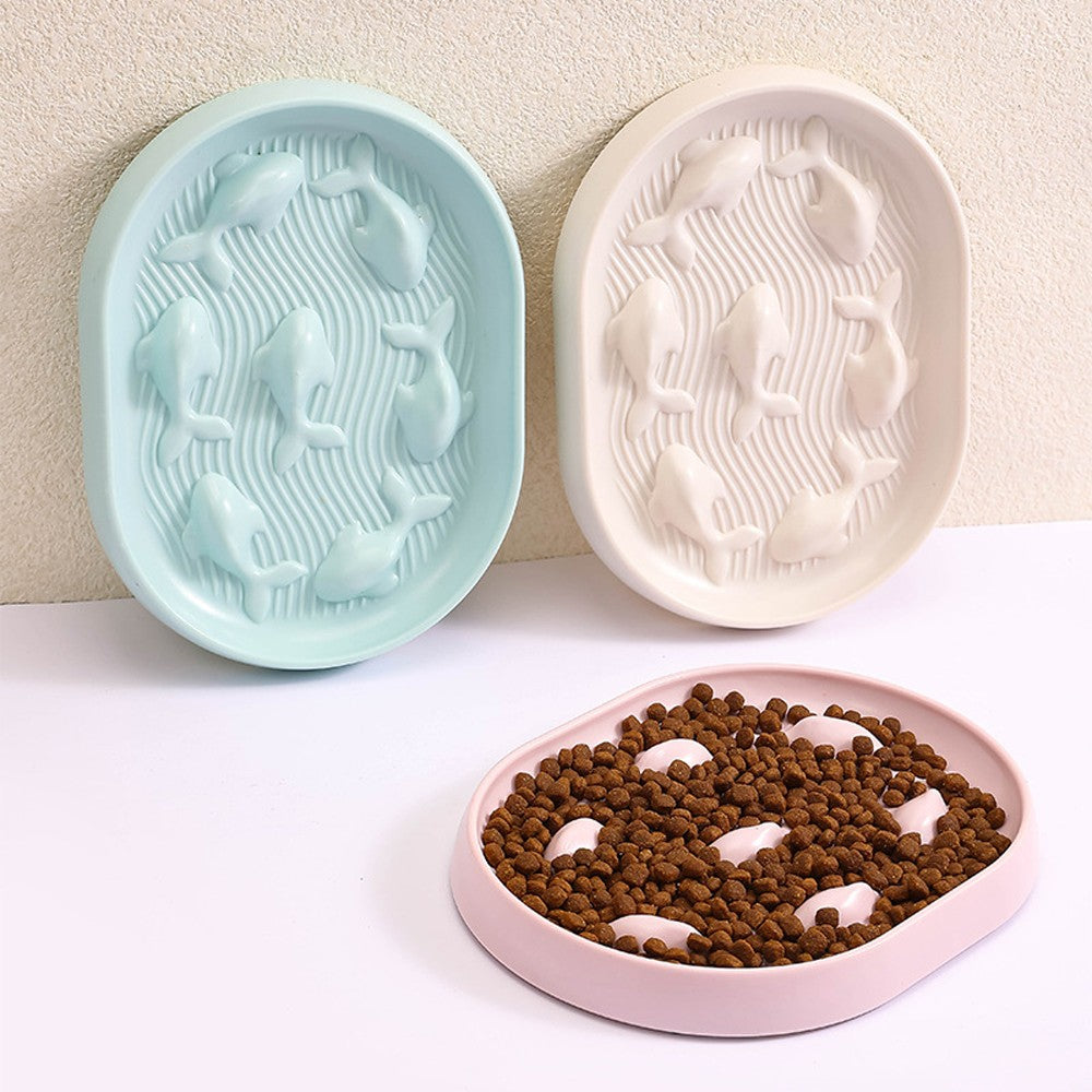 Blue and cream fish slow feeder bowls with a pink bowl full of kibble