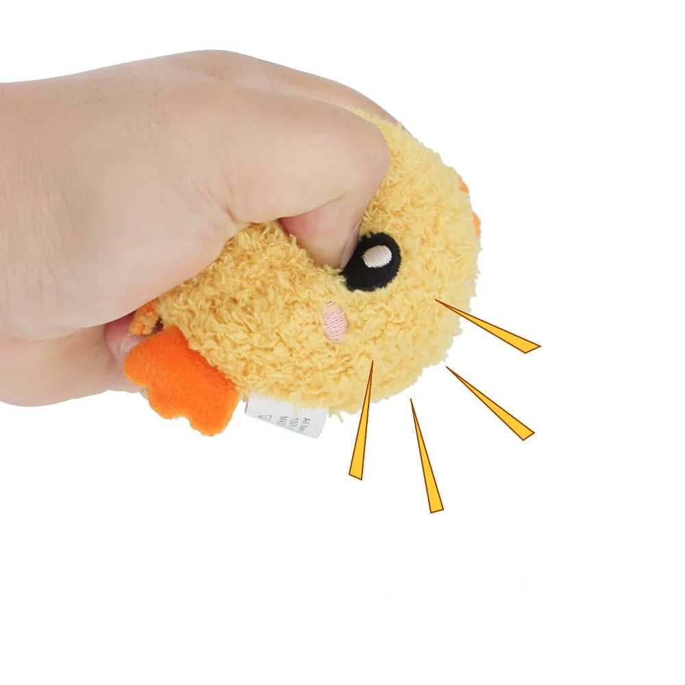Hand squeezing the chick toy to sound the squeaker